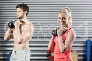 Couple lifting dumbbells together