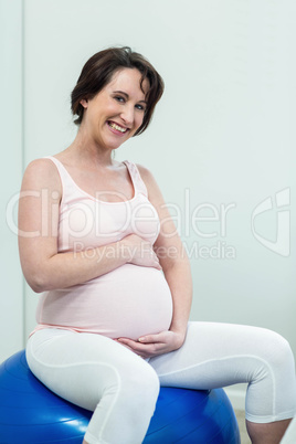 Pregnant woman sitting on exercise ball