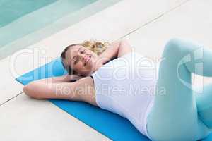 Pregnant woman resting on mat