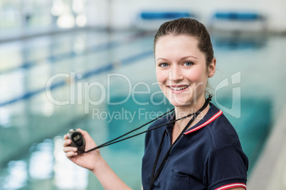 Pretty trainer holding stopwatch