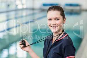 Pretty trainer holding stopwatch