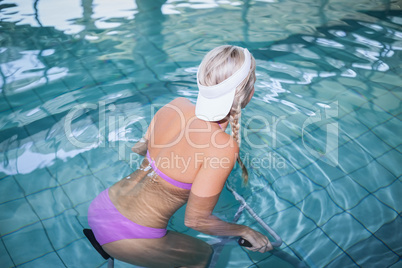 Fit woman doing underwater bike