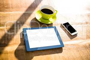 Cup of coffee and tablet pc