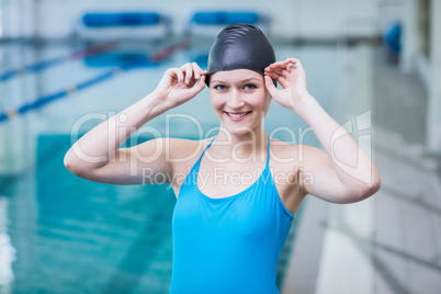 Cute woman wearing swim cap