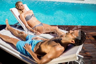 Couple relaxing on deckchairs
