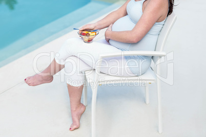 Pregnant woman eating fruit