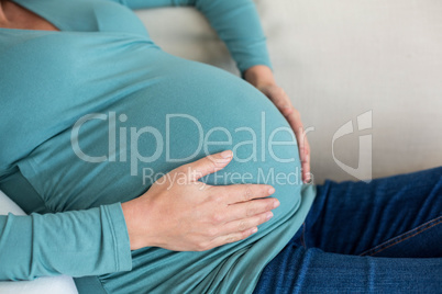 Pregnant woman touching her belly