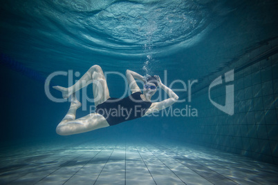 Pretty woman stretching underwater