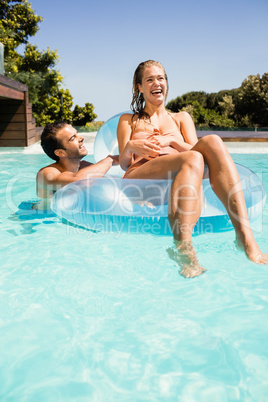 Happy couple in the pool with lilo