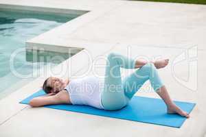 Pregnant woman resting on mat