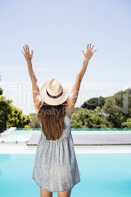 Rear view of brunette raising hands