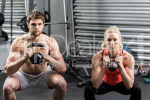 Couple lifting dumbbells together