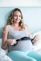 Pregnant woman making her belly listen to music