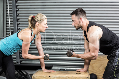 Couple lifting dumbbells together