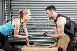 Couple lifting dumbbells together