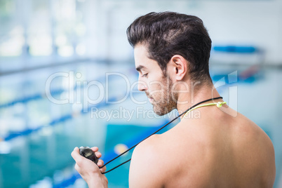 Handsome man holding stopwatch