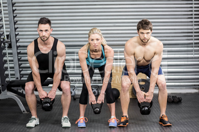 Fit people lifting dumbbells