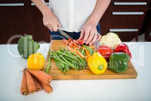 Pregnant woman cutting vegetables