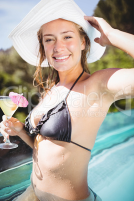 Smiling woman holding cocktail