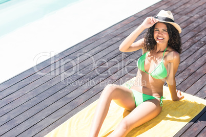 Fit brunette sitting on towel