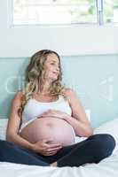 Pregnant woman touching her belly