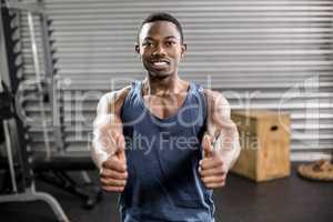 Fit man with thumbs up