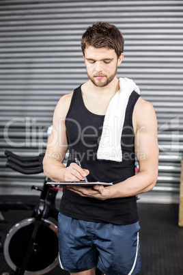 Trainer taking notes at crossfit gym