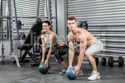 Fit couple doing ball exercise