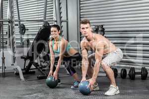 Fit couple doing ball exercise