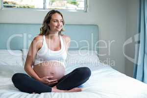 Pregnant woman resting on her bed