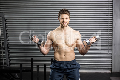 Front view of serious man lifting weight