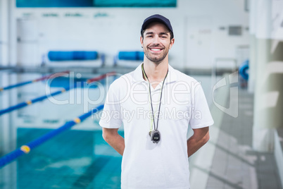 Handsome trainer standing with hands on the back