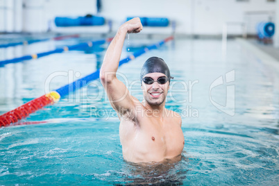 Handsome man triumphing with raised arms