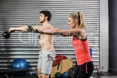 Couple lifting dumbbells together