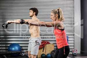 Couple lifting dumbbells together