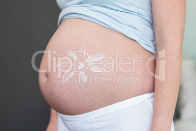 Pregnant woman with cream on her belly