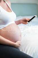 Pregnant woman using smartphone