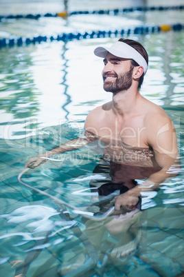 Smiling man doing underwater bike