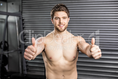 Shirtless fit man with thumbs up