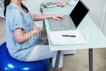 Pregnant woman on exercise ball Pregnant woman on exercise ball