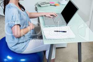 Pregnant woman on exercise ball