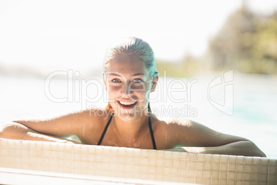 Portrait of smiling blonde in the pool