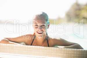 Portrait of smiling blonde in the pool