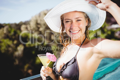 Smiling woman holding cocktail