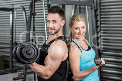 Couple posing with dumbbells