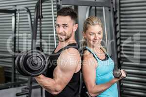 Couple posing with dumbbells