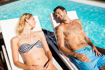 Cute couple relaxing on deckchairs