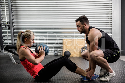 Fit couple doing abdominal ball exercise