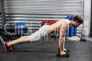Man doing push up with dumbells