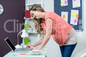 Pregnant woman using laptop